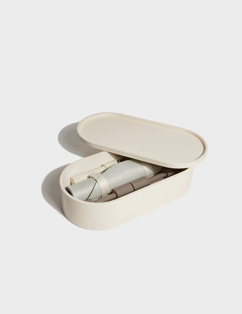 Beige color Capsula Workout Kit which includes - storage, mat, resistance bands and dumbbells