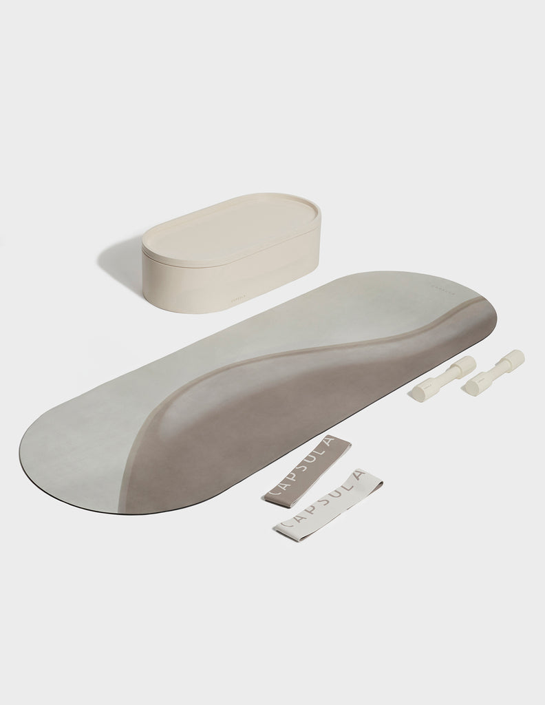 Beige color Capsula Workout Kit which includes - storage, mat, resistance bands and dumbbells