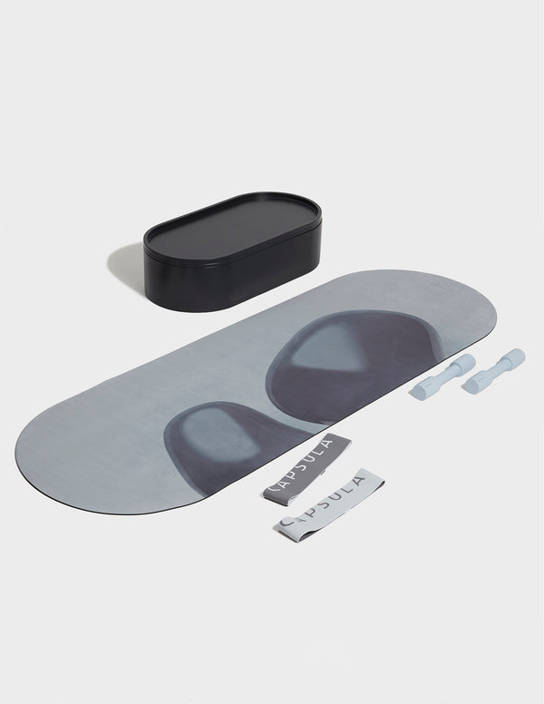 Blue grey Capsula Workout Kit which includes - storage, mat, resistance bands and dumbbells